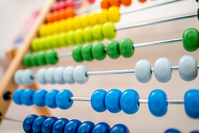 Multicolored beads on an abacus.