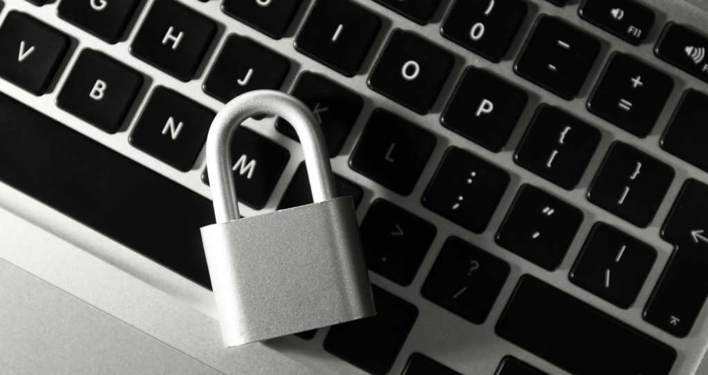 A silver lock lying on a laptop keyboard.